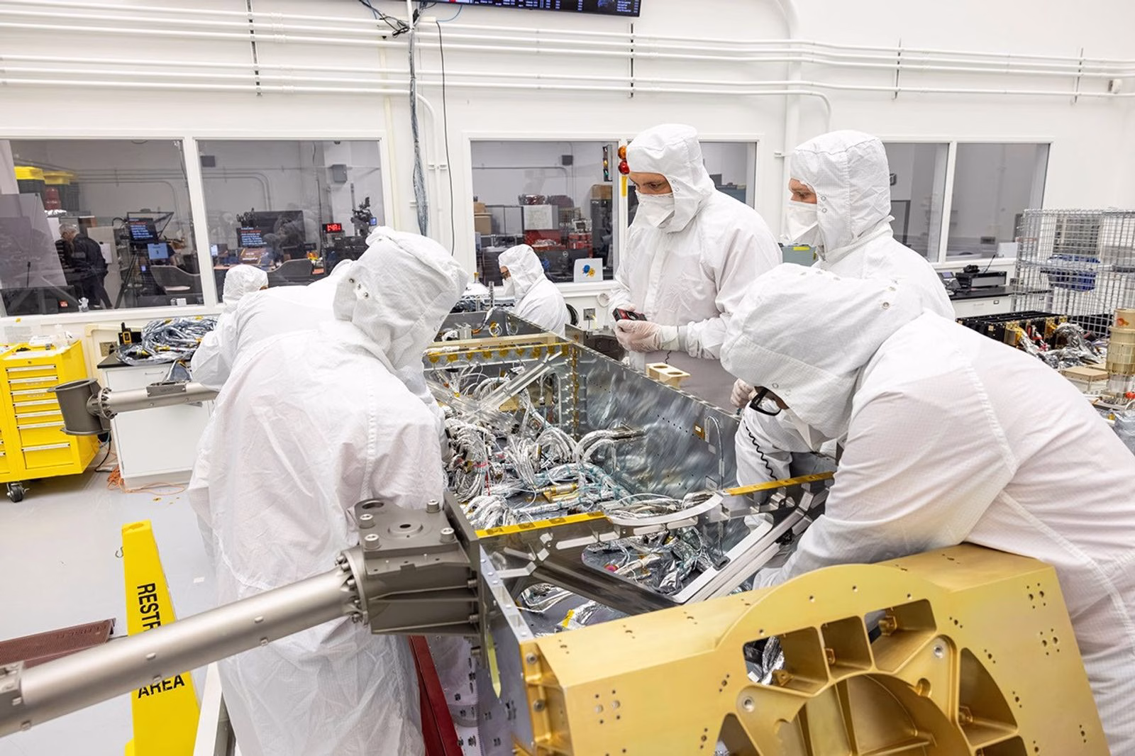 Technicians installing Dragonfly's electrical harness in the Johns Hopkins APL clean room